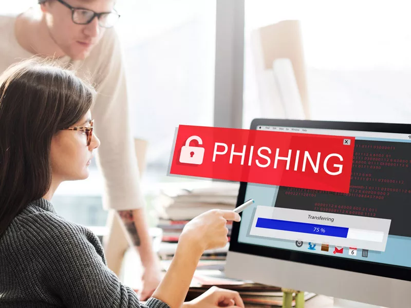 colleagues looking at a screen with the word Phishing superimposed to illustrate non secure remote access risks