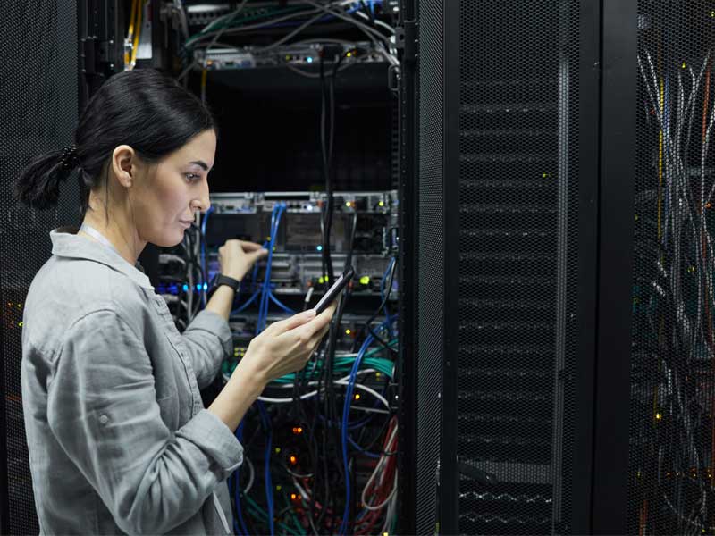 woman working with a server to illustrate IT outsourcing