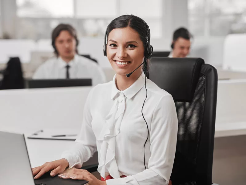 friendly female in IT help desk outsourcing center