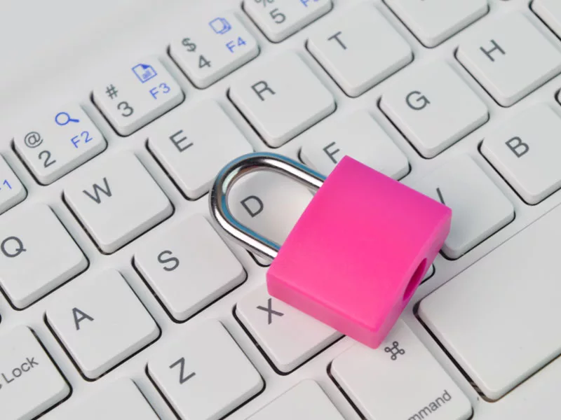 pink padlock on a computer keyboard to illustrate cybersecurity for small businesses