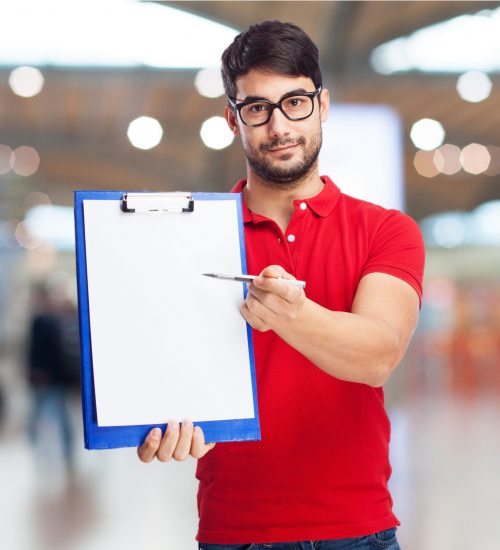 A young business man showing moving IT checklist